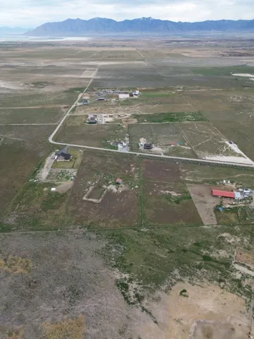 Aerial overview of property's location featuring rural landscape and a mountainous background