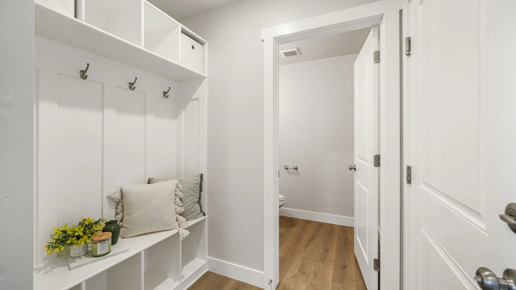 Built-in mudroom bench with storage cubbies and coat hooks