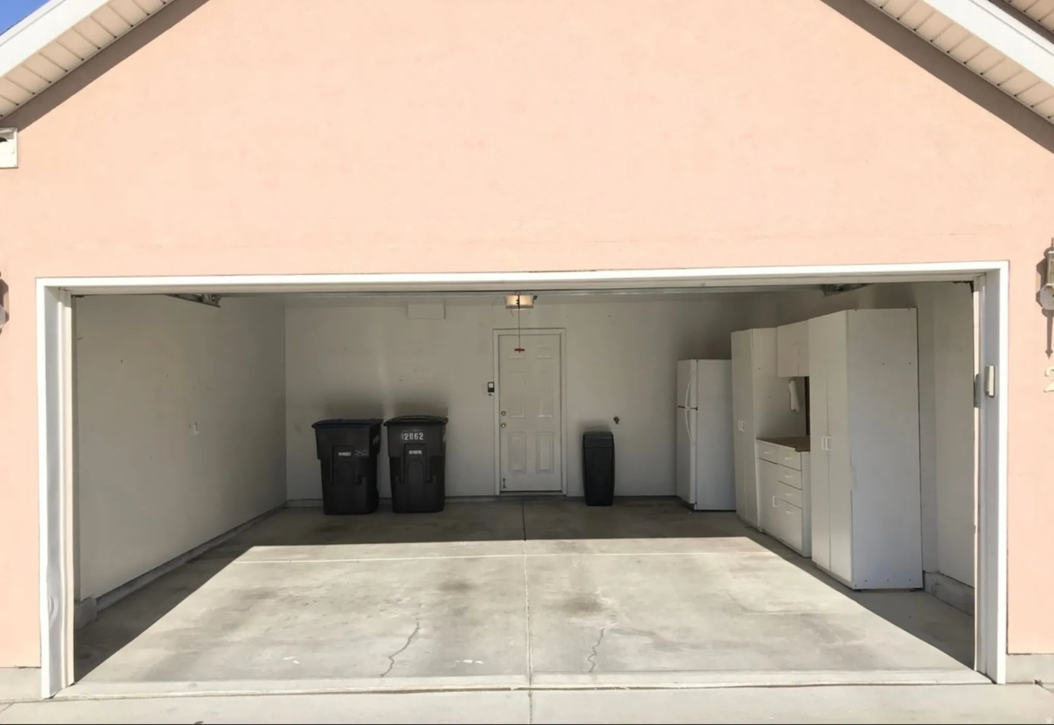 Garage with freestanding refrigerator and wooden ceiling