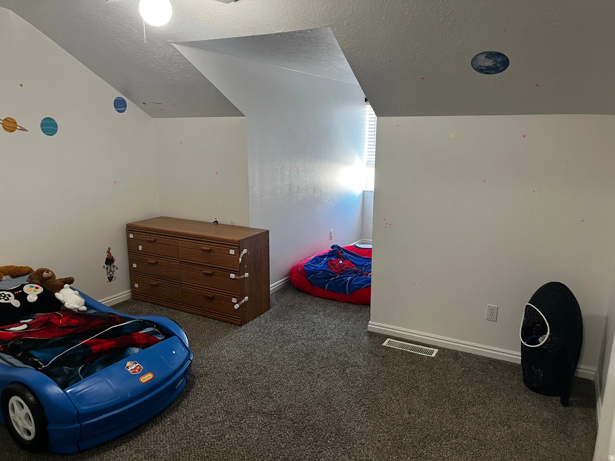 Bedroom featuring dark carpet and a textured ceiling