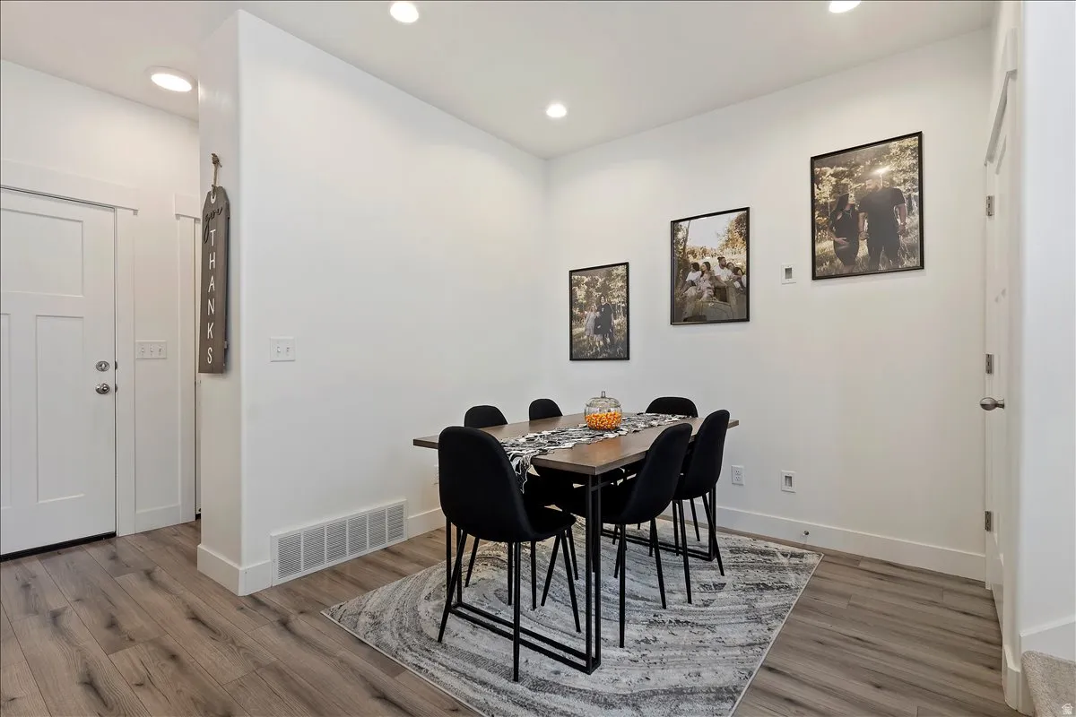Dining room with recessed lighting and light wood-style flooring
