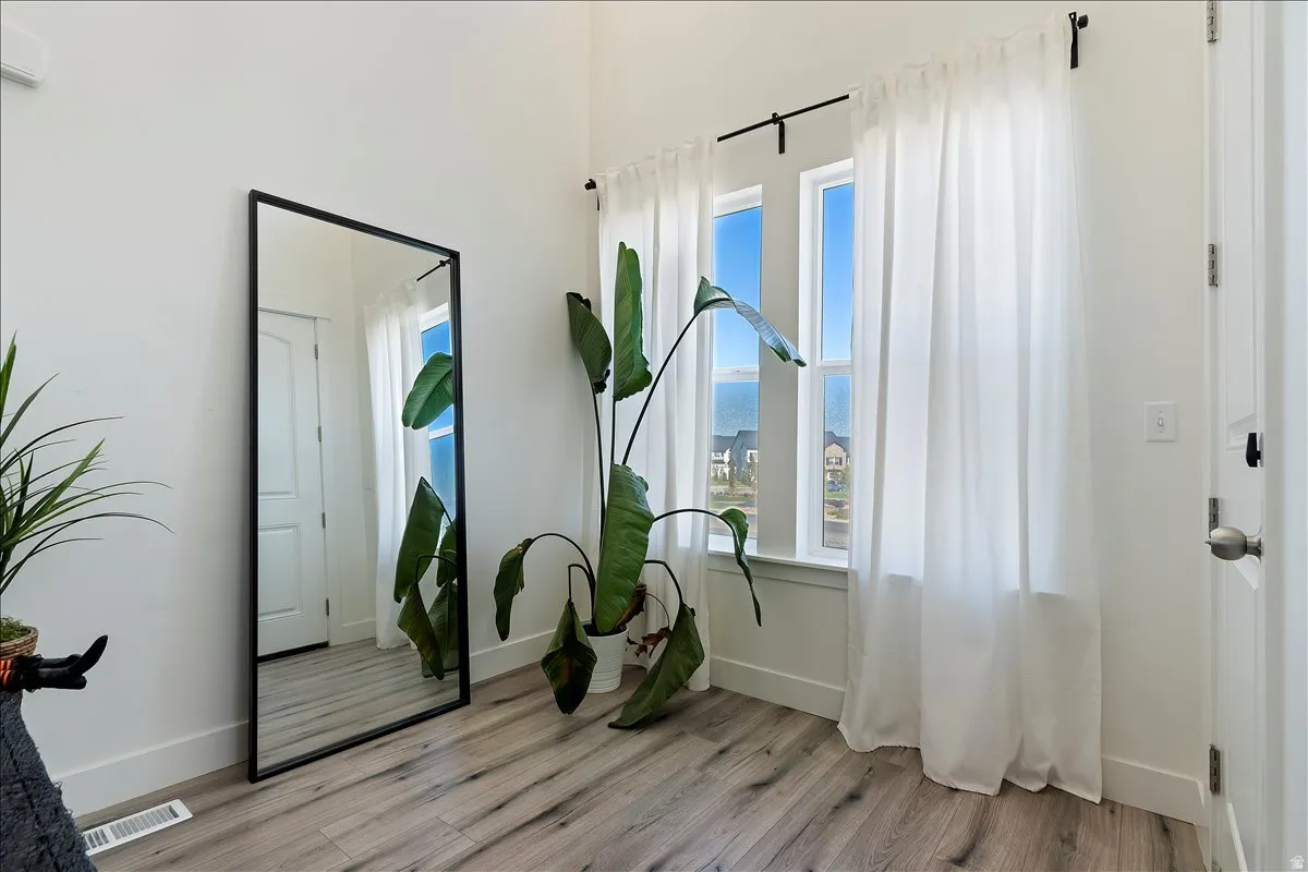 Foyer with light wood-style floors and baseboards