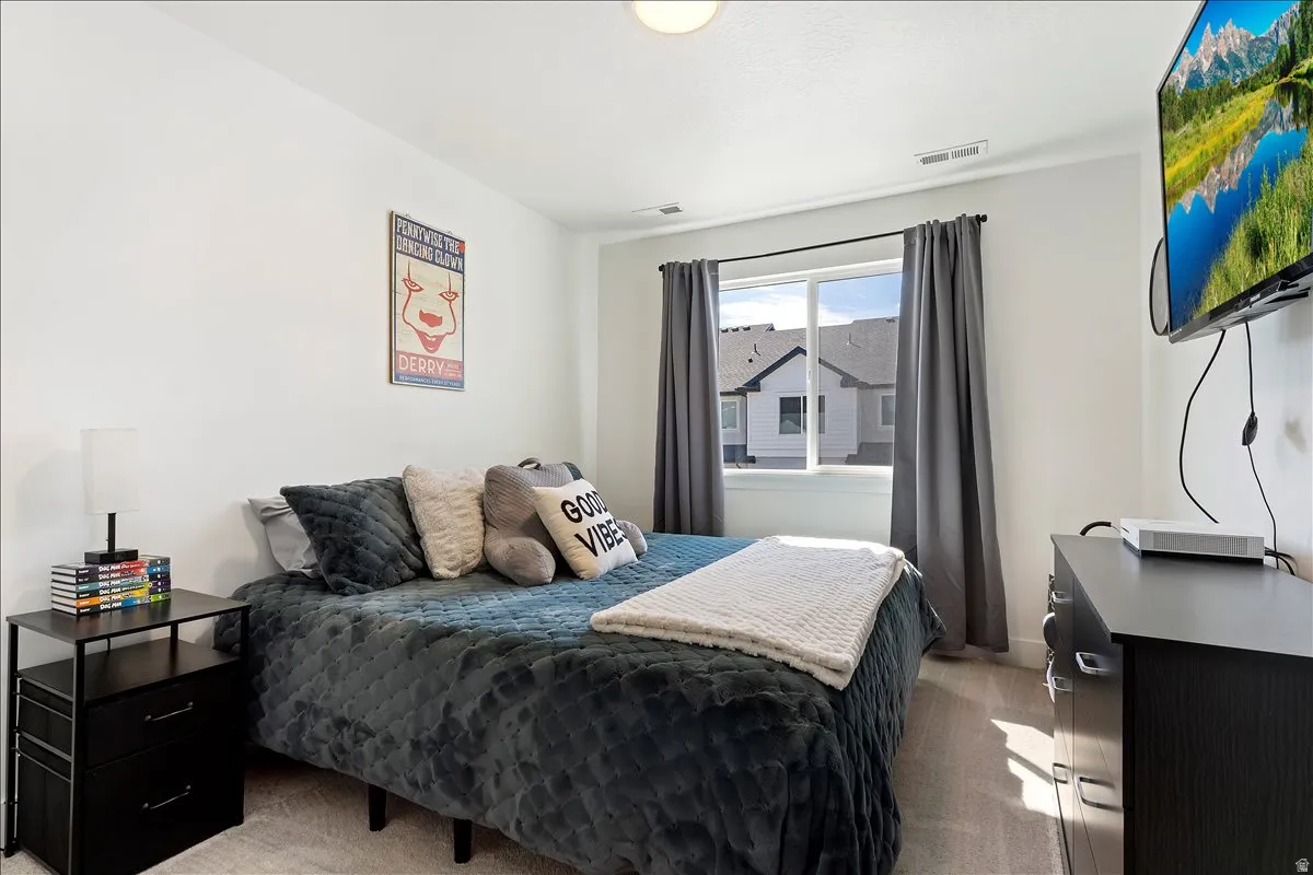 Bedroom with light colored carpet