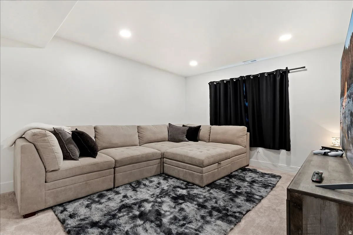 Living room featuring light carpet and recessed lighting