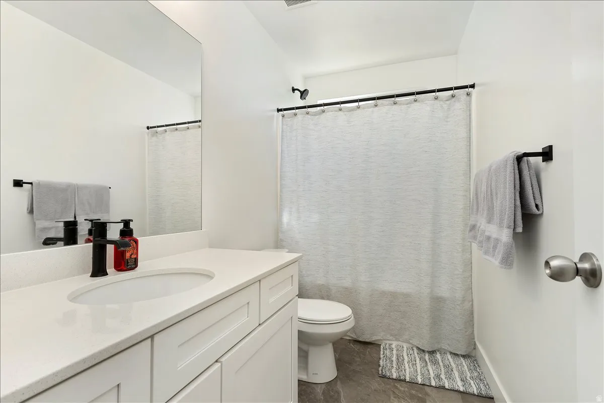 Bathroom featuring vanity and a shower with curtain