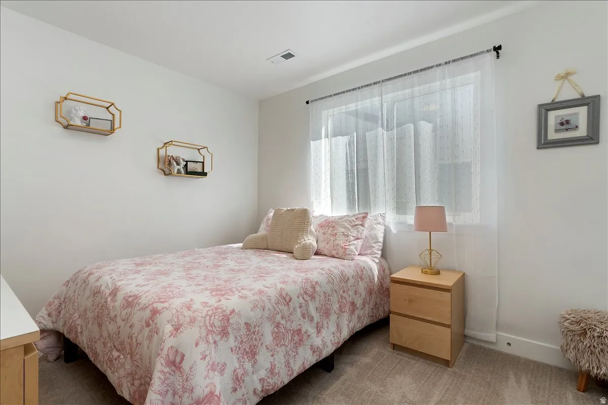 Bedroom with carpet flooring and baseboards