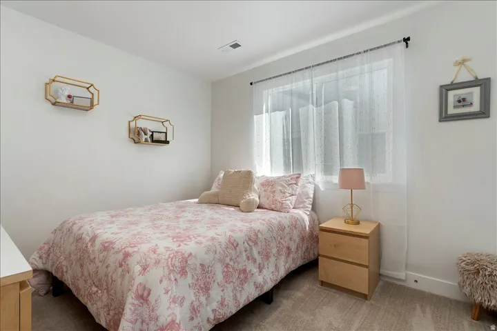 Bedroom with carpet flooring and baseboards