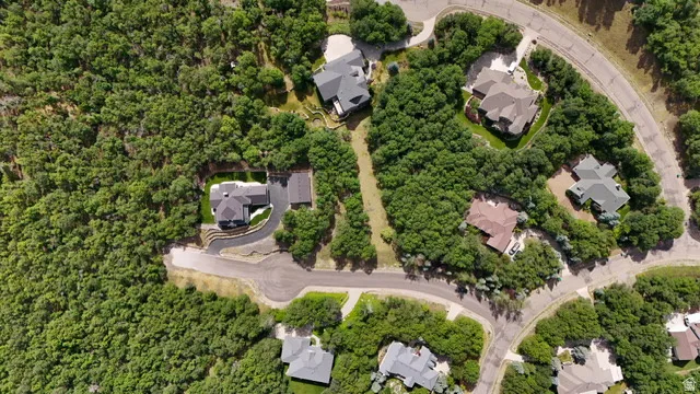 Estate property featuring a dark-toned residence with a multi-gabled roofline and an attached garage