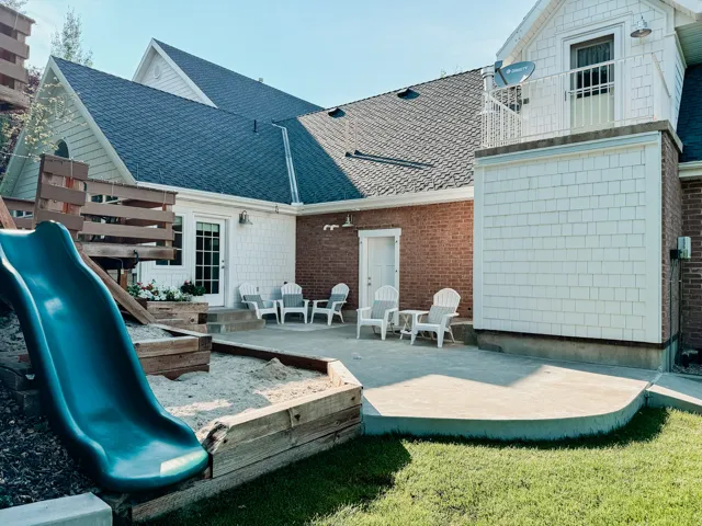 Back of property featuring a patio area and a shingled roof