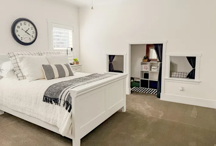 Carpeted bedroom with ornamental molding and baseboards