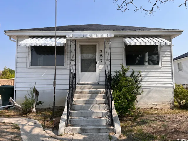Bungalow-style house with entry steps and roof with shingles