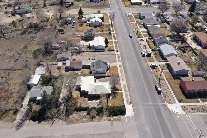 Aerial view of property's location with nearby suburban area