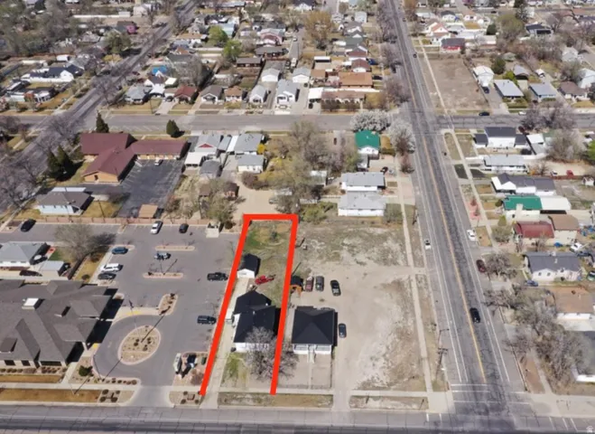 Aerial overview of property's location featuring nearby suburban area and property parcel outlined