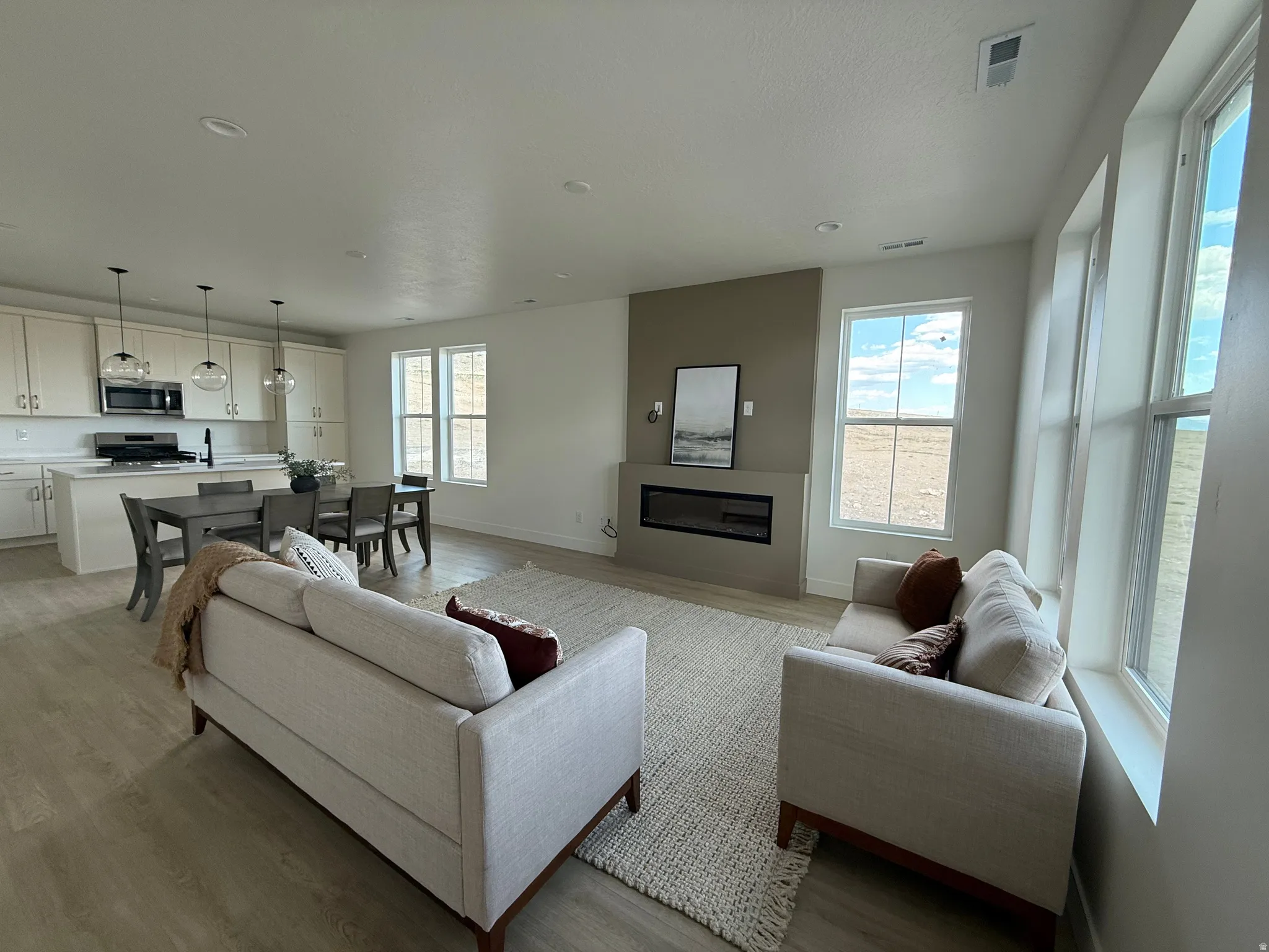 Living area with light wood-type flooring and a fireplace