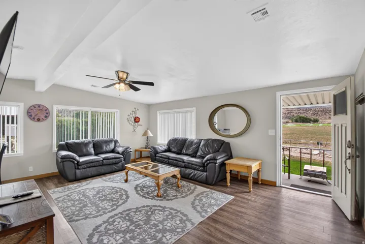 Unit 3: Wood-finish flooring, recessed lighting, and a ceiling fan with integrated lighting