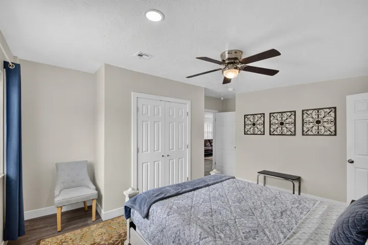 Unit 1: Recessed ceiling lighting, ceiling fan with integrated light, wood-finish flooring, two-panel interior doors, and a double-door closet