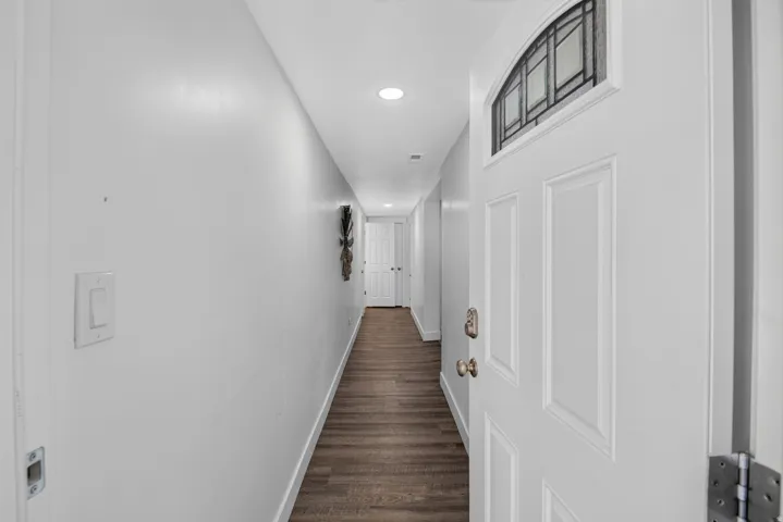 Unit 2B: Entry door with decorative arched transom window and paneling