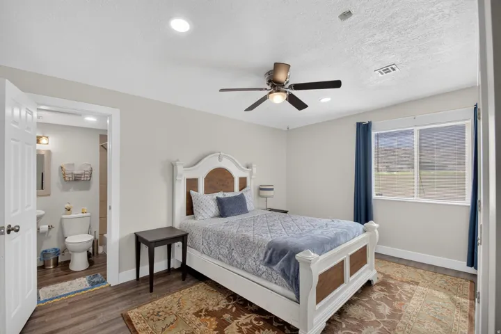Unit 1: Wood-finish flooring, recessed ceiling lighting, and a ceiling fan with integrated lighting