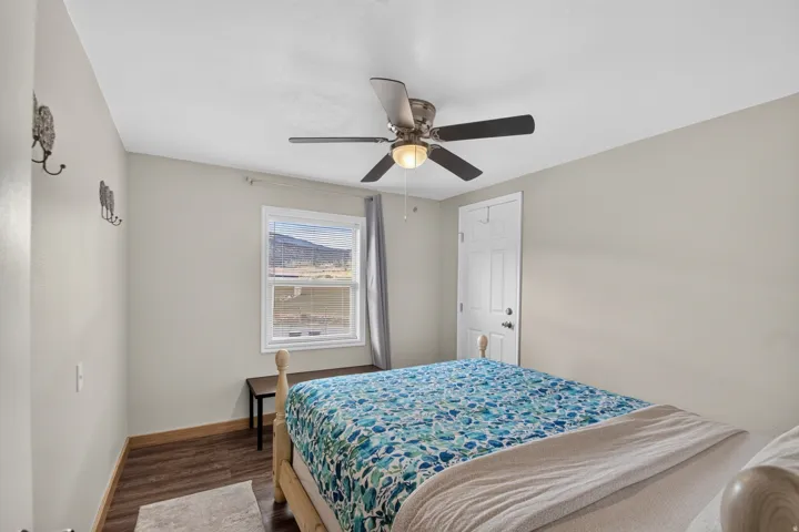 Unit 3: Recessed window with exterior scenery, wood-finish flooring, ceiling fan with integrated lighting, and a paneled entry door