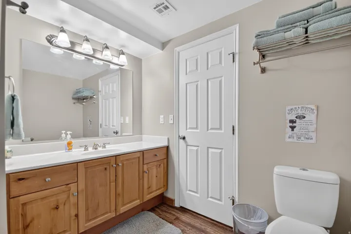 Unit 3: Double vanity with a white countertop and wood-finish cabinetry