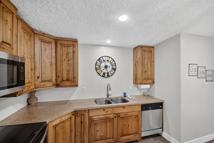 Unit 1: Wood-finish cabinetry paired with a speckled countertop