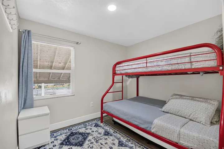 Unit 1: Recessed ceiling lighting, wood-finish flooring, and a window with blinds