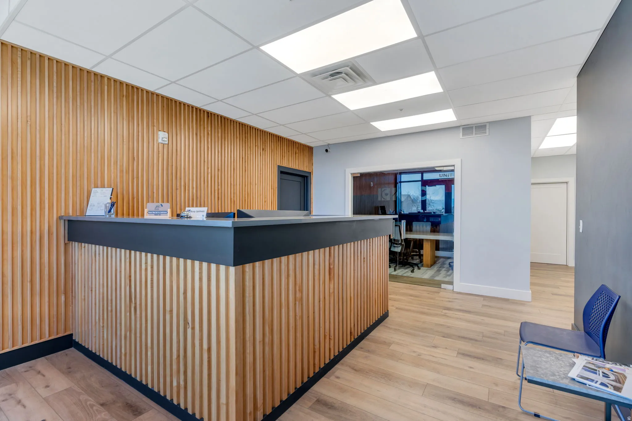 Reception with wooden walls and a drop ceiling