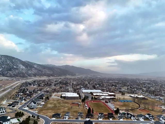 Aerial perspective of suburban area featuring a mountain backdrop