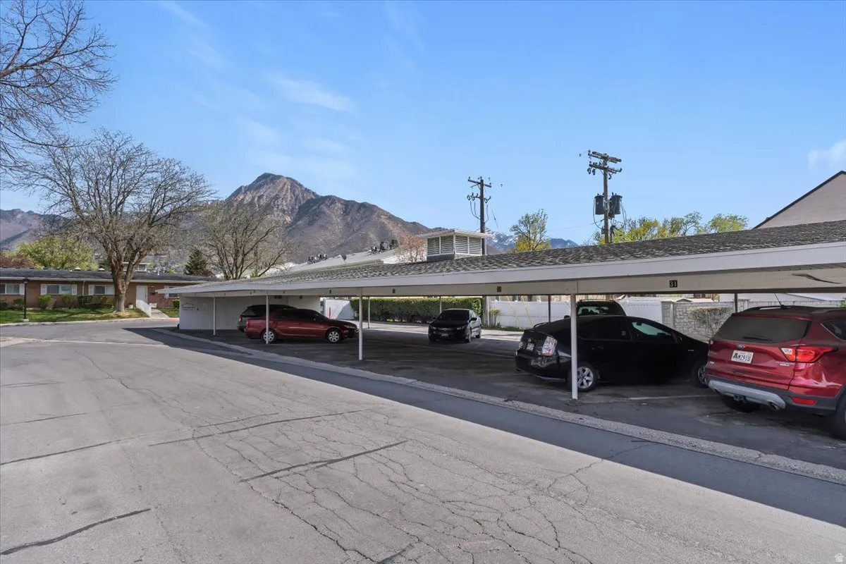 Covered parking lot featuring a mountain view