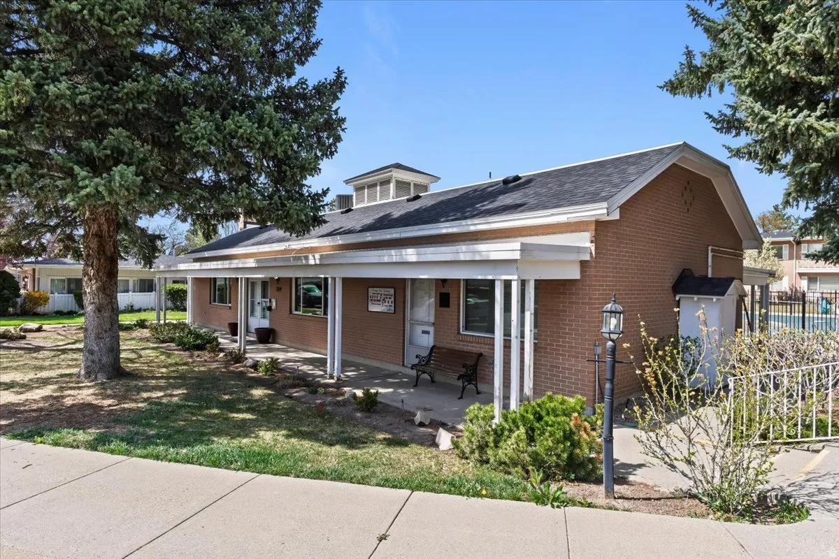 Bungalow-style house with covered porch and brick siding