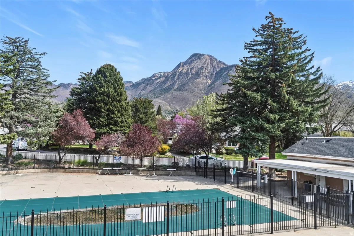 Community pool with a mountain view and a patio