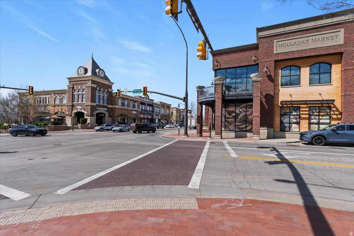 View of decorative street with traffic lights, sidewalks, curbs, and street lighting