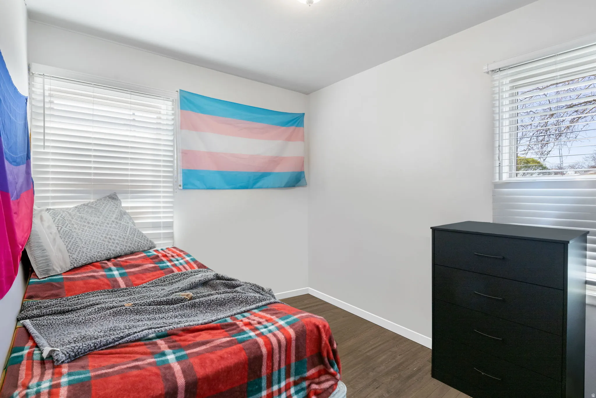 Bedroom 1 with baseboards and dark wood-style flooring