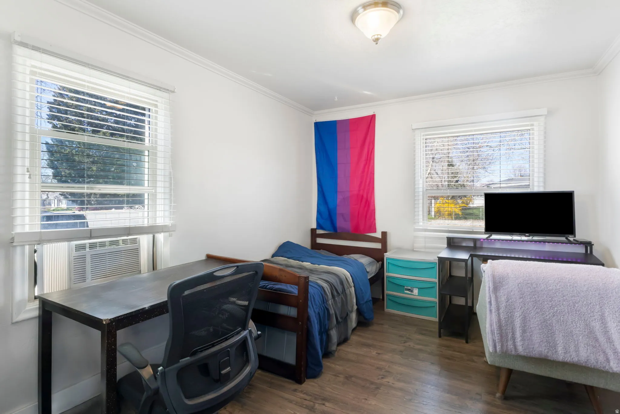 Bedroom 2 with dark wood-style flooring, a desk, crown molding, and cooling unit