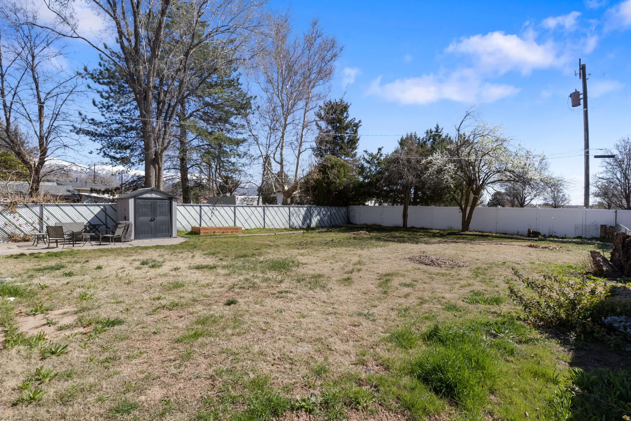 Unit A Private Fenced backyard featuring a storage shed