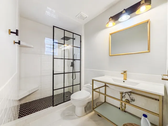 Full bath with a walk in shower, wainscoting, and tile walls