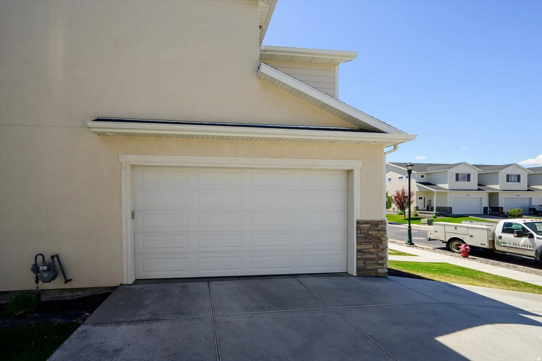 Garage featuring concrete driveway