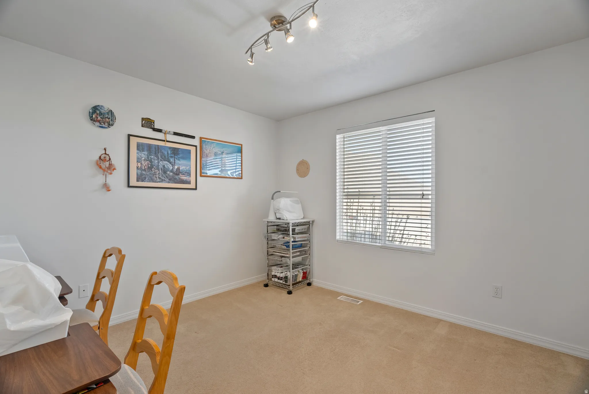 Office with light colored carpet and baseboards