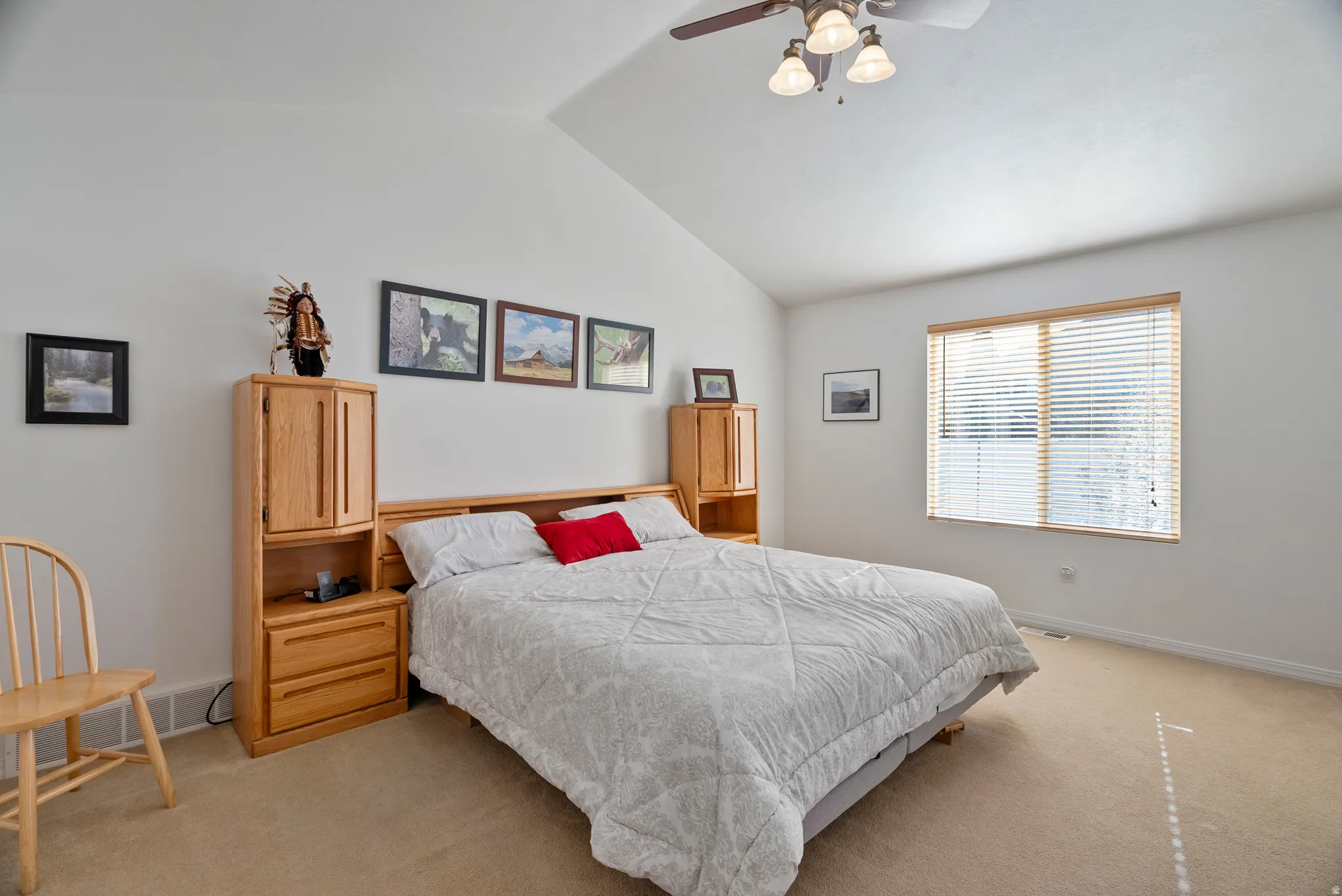 Bedroom with light carpet, lofted ceiling, and ceiling fan