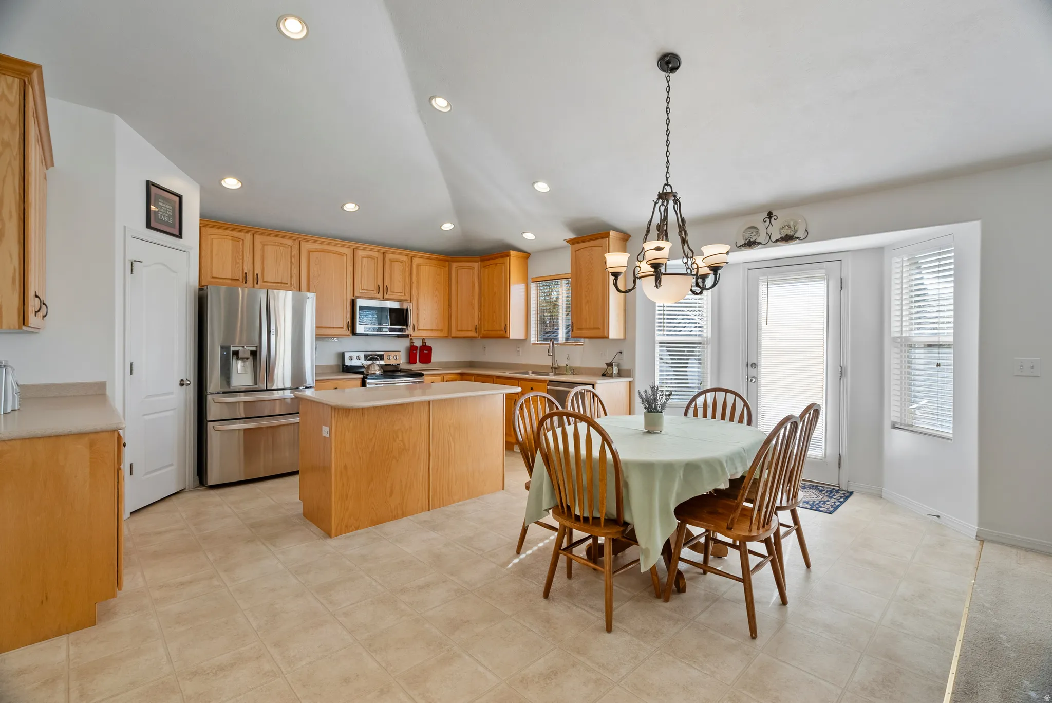 Dining space featuring suspended lighting and lofted ceiling