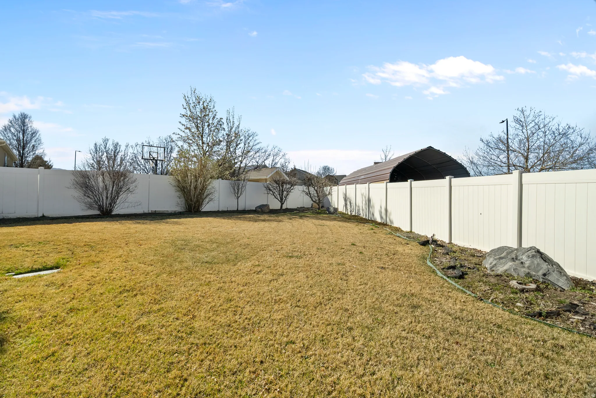View of fenced backyard