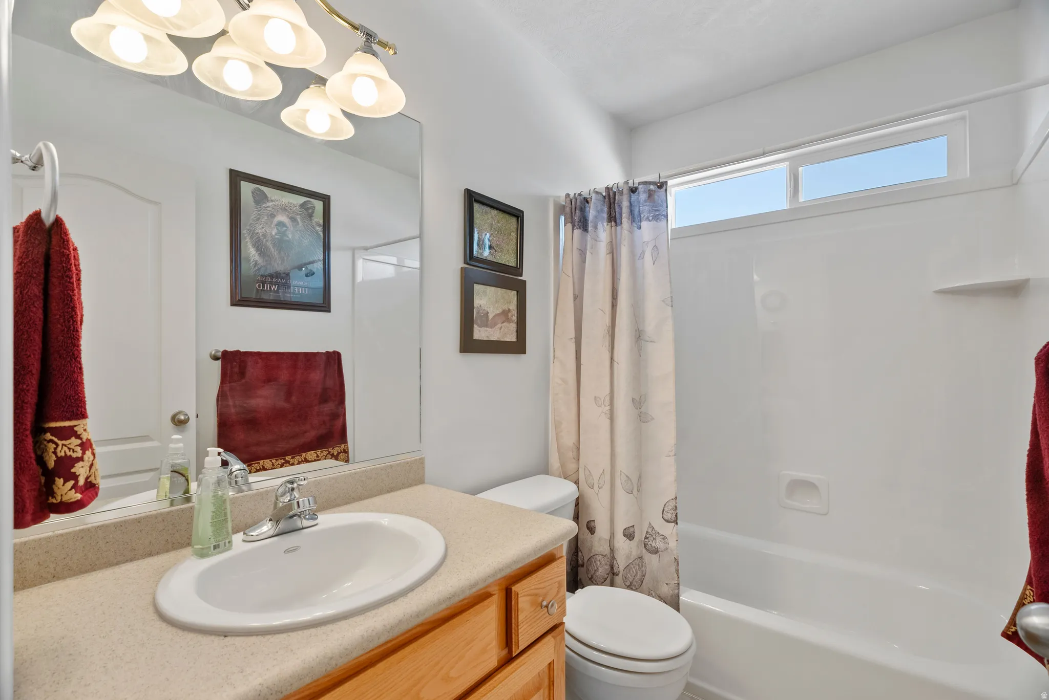 Bathroom featuring vanity and shower / bath combo