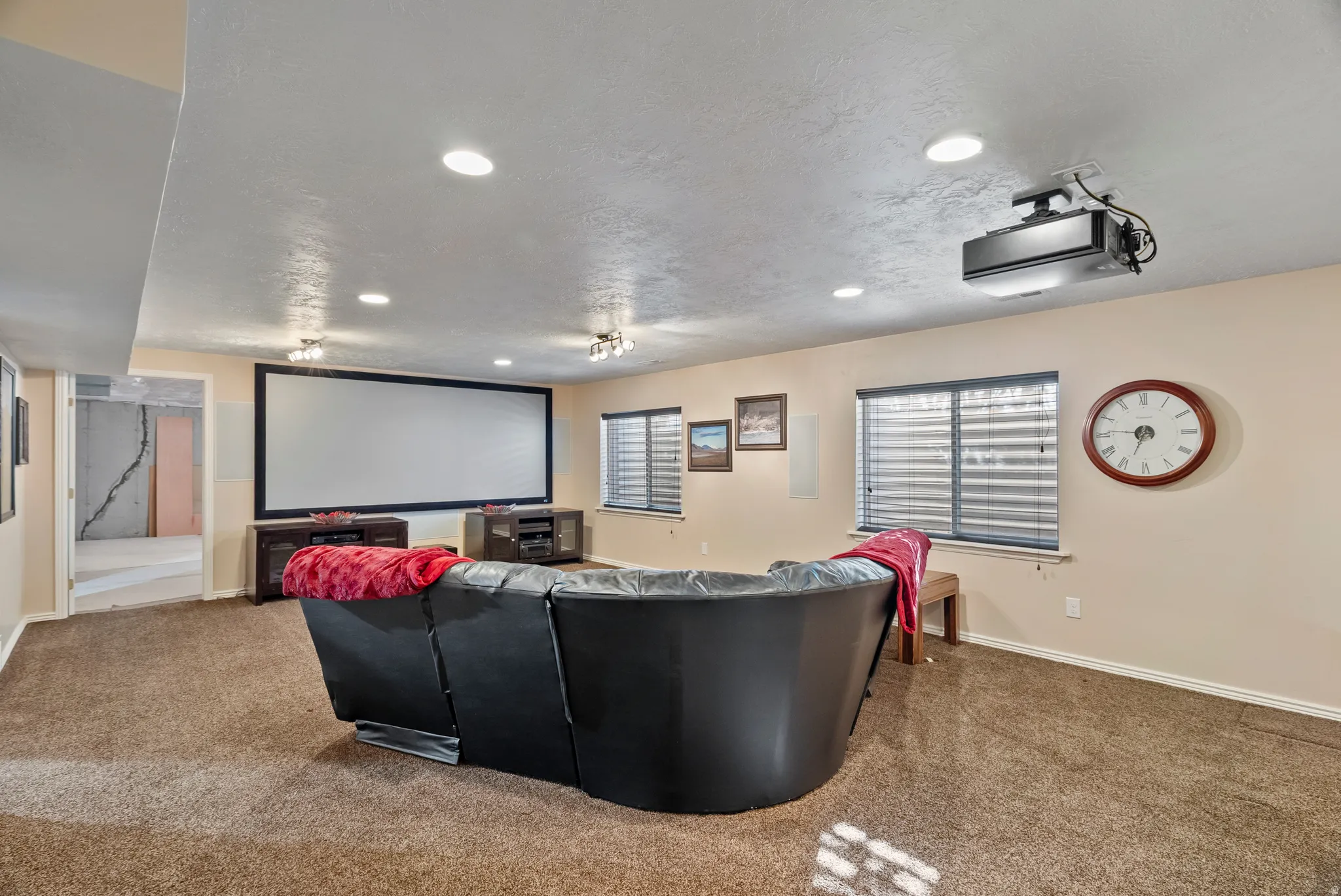 Carpeted home theater featuring recessed lighting and a textured ceiling