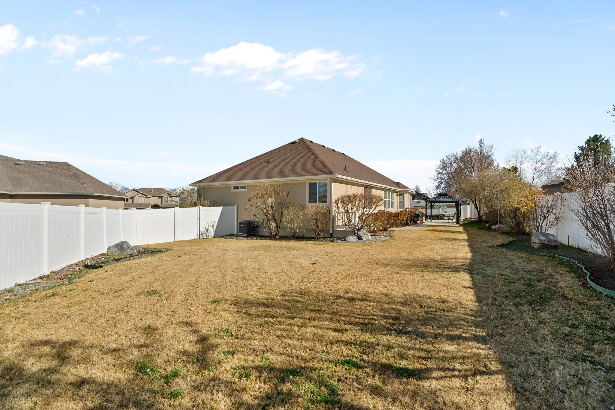 Fenced backyard with a gazebo