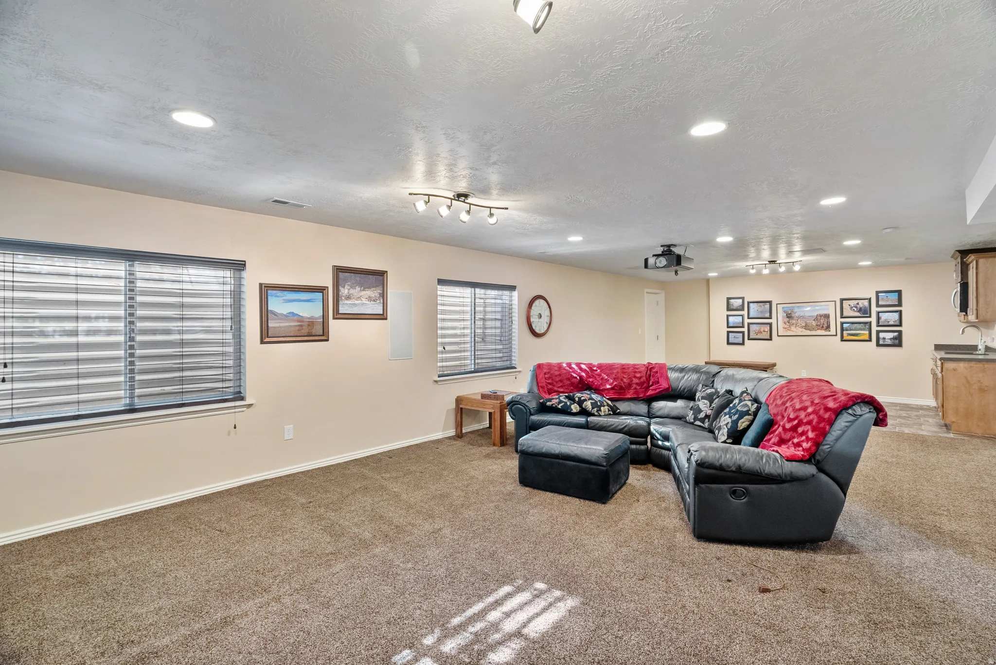 Living room featuring carpet flooring, recessed lighting, and a textured ceiling