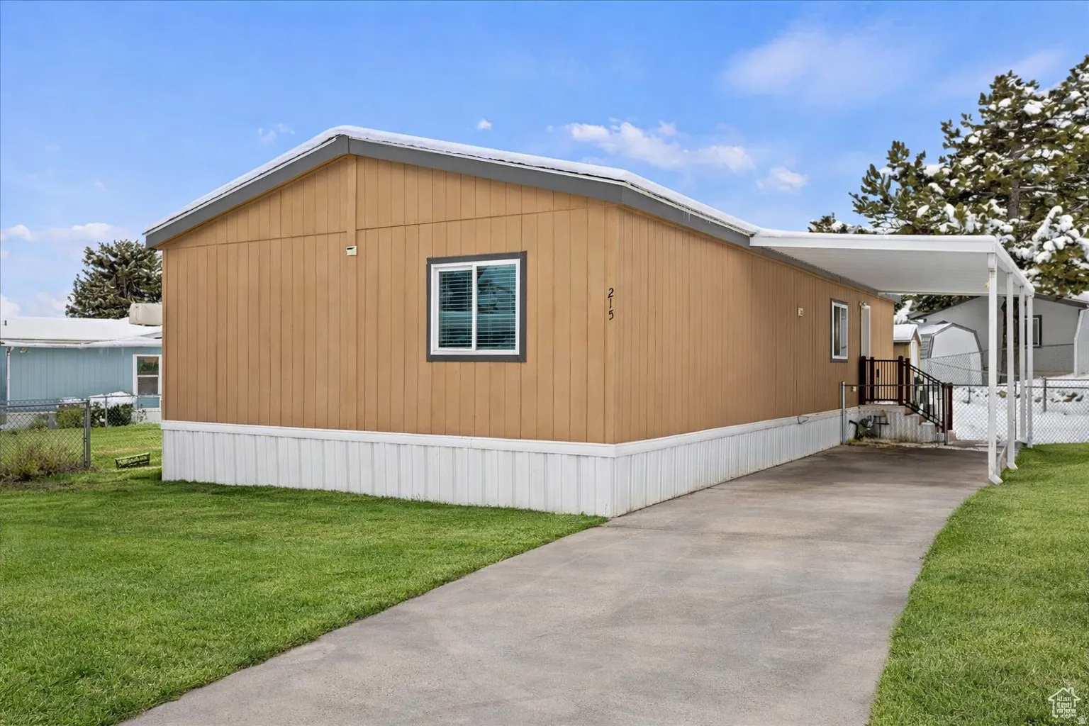 View of home's exterior with driveway and a carport