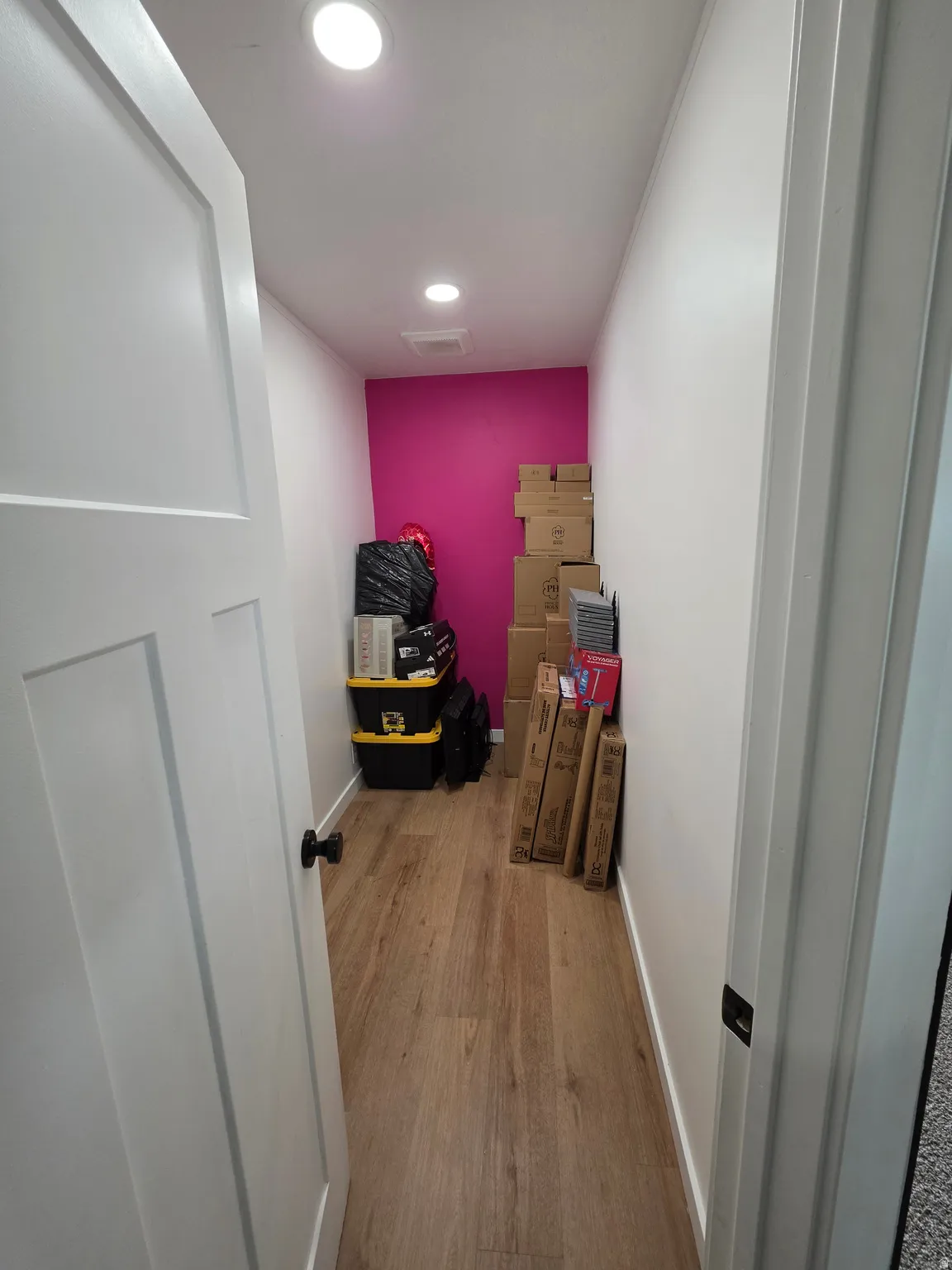 Corridor with light wood-style floors and recessed lighting
