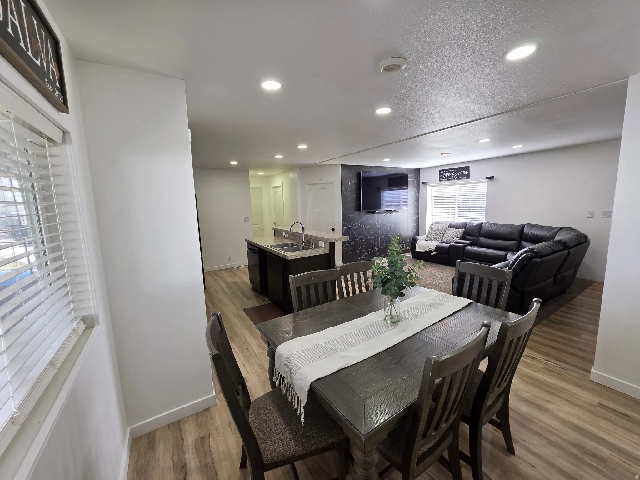 Dining room with light wood-type flooring and recessed lighting