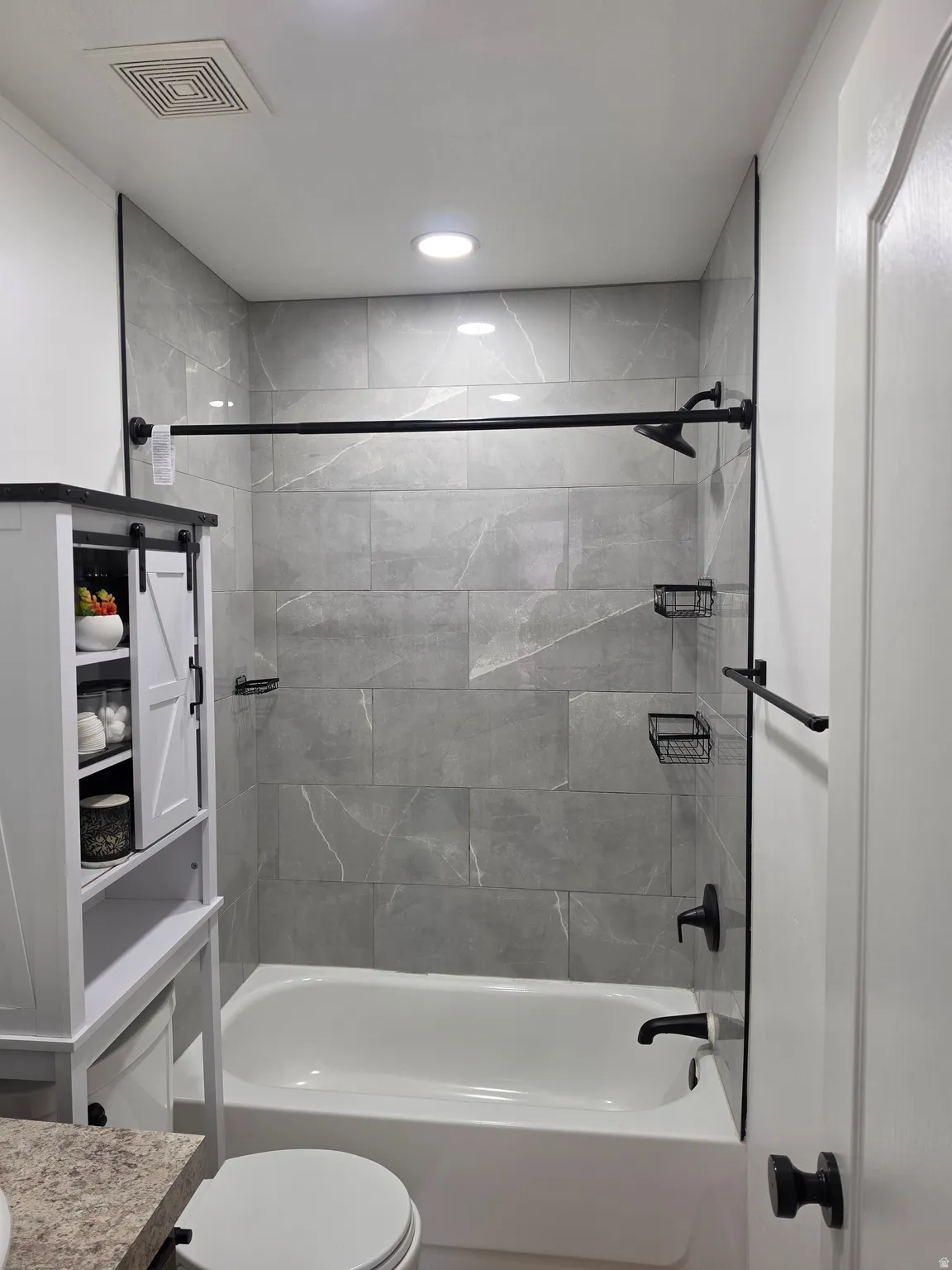 Bathroom with vanity and bathtub / shower combination
