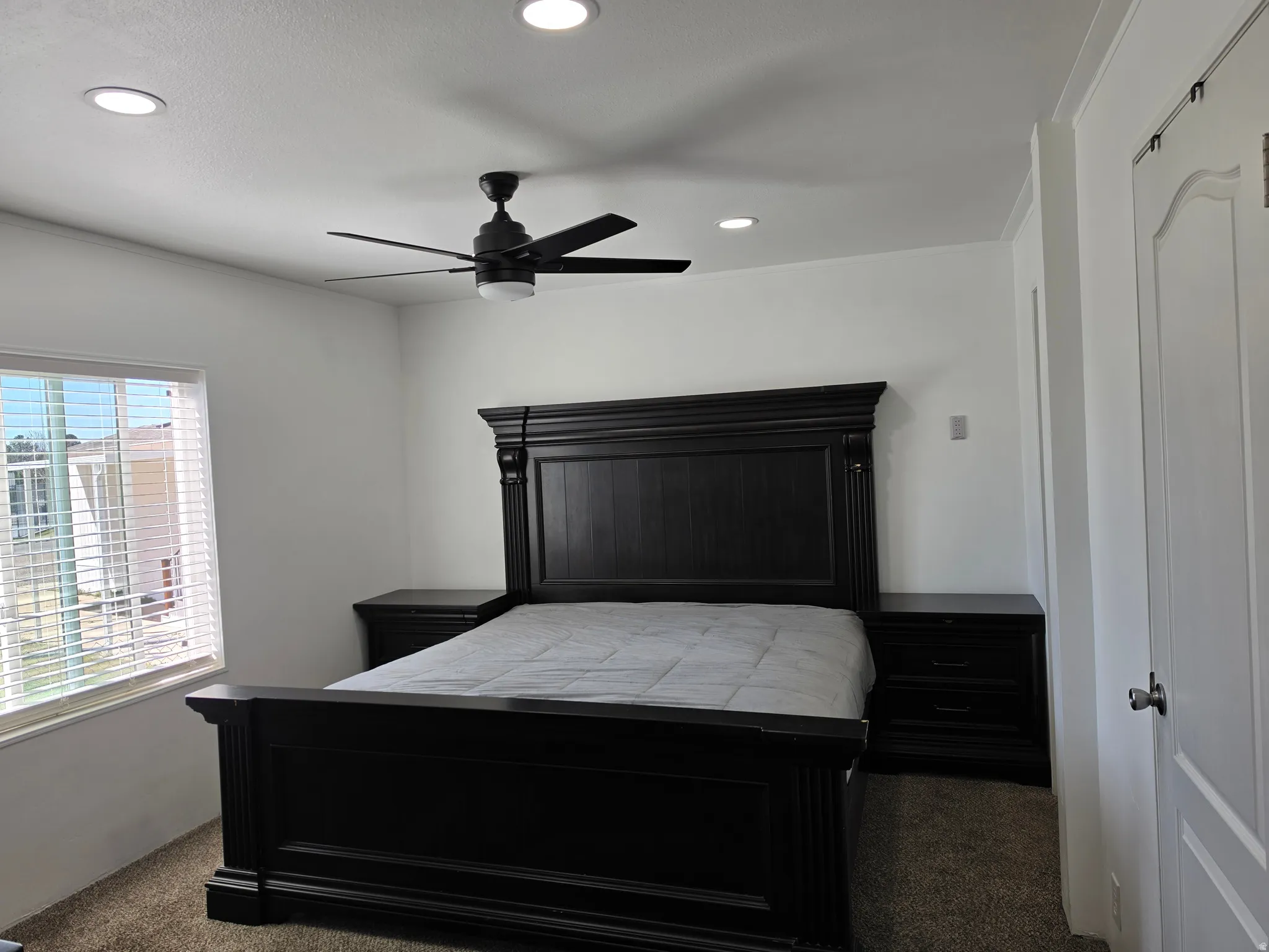 Bedroom featuring dark carpet, a ceiling fan, and recessed lighting